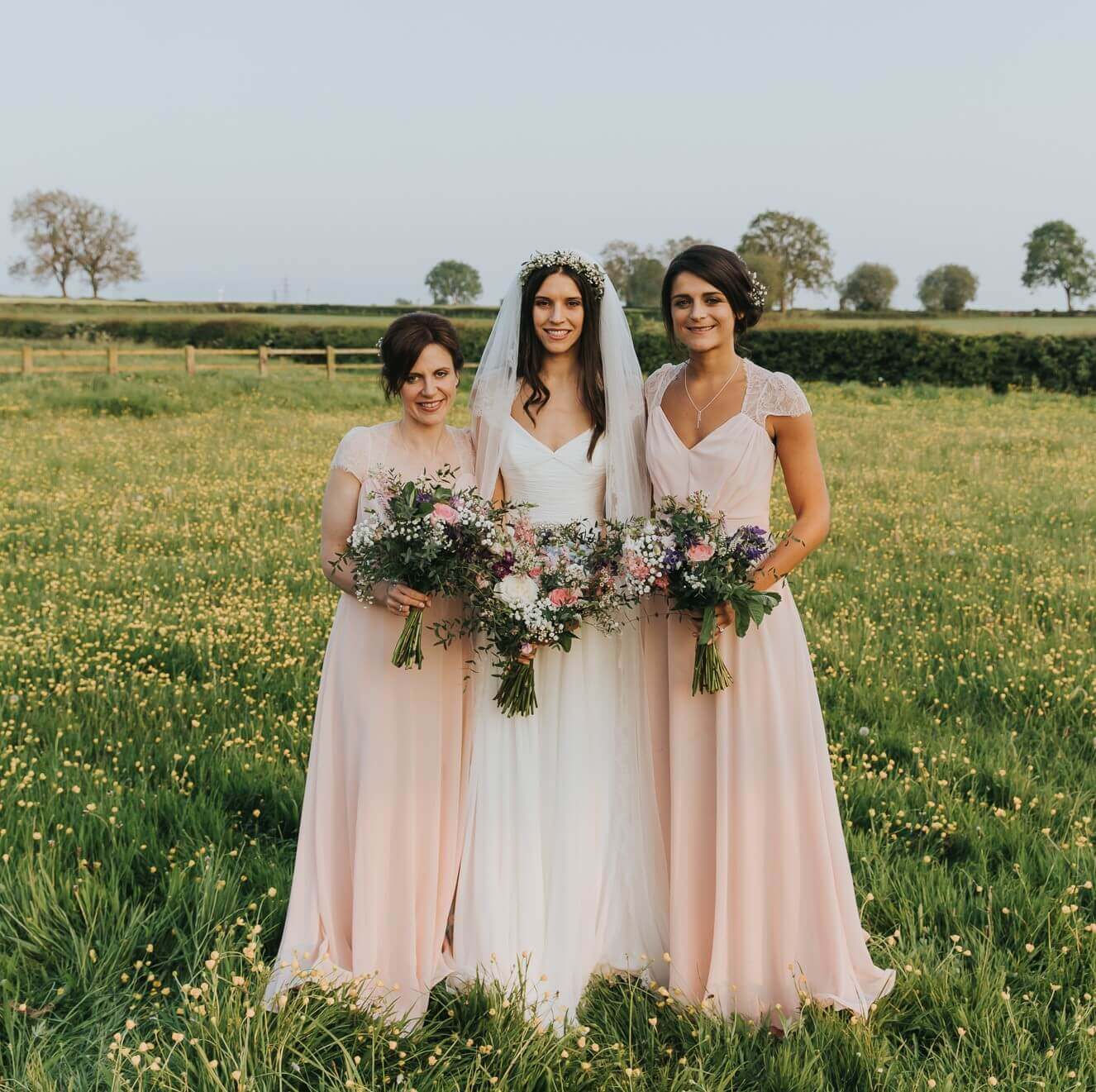 Bride and bridesmaids pink and cream Bridge House Barn summer wedding